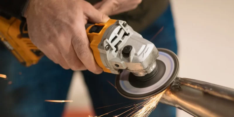 man fixing motorcycle modern workshop scaled